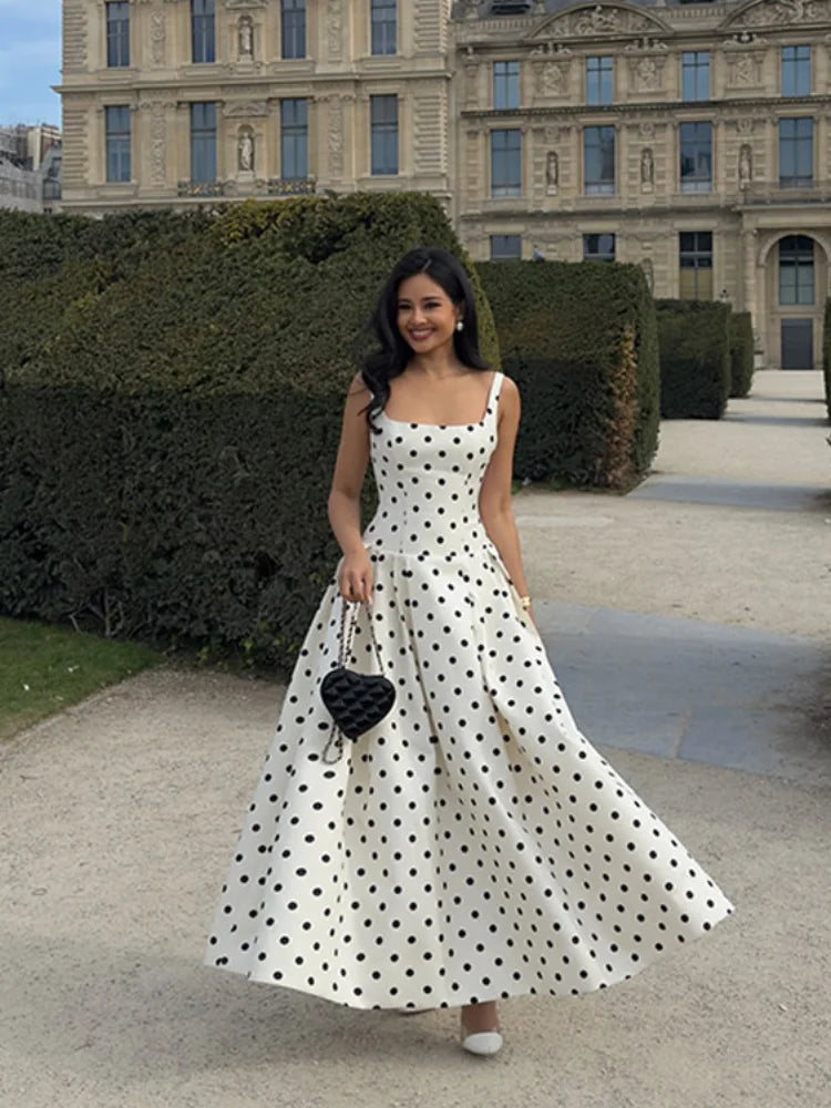 Woman in a polka dot maxi dress, perfect for summer casual and retro chic outfits.