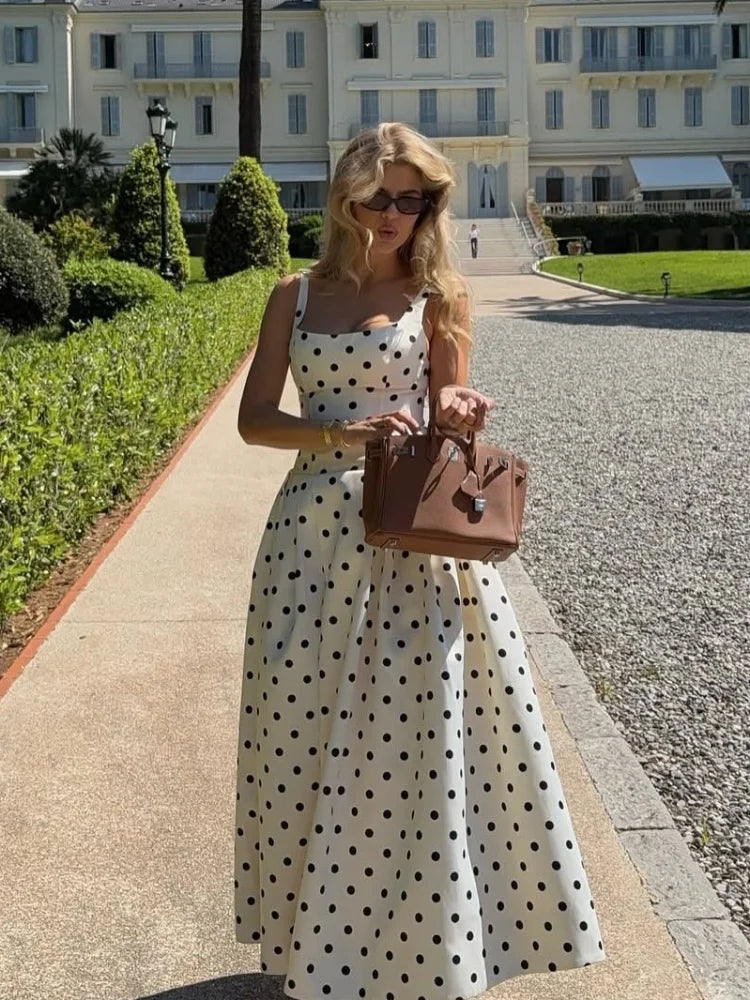 Woman in a polka dot maxi dress, perfect for summer casual and retro chic outfits.