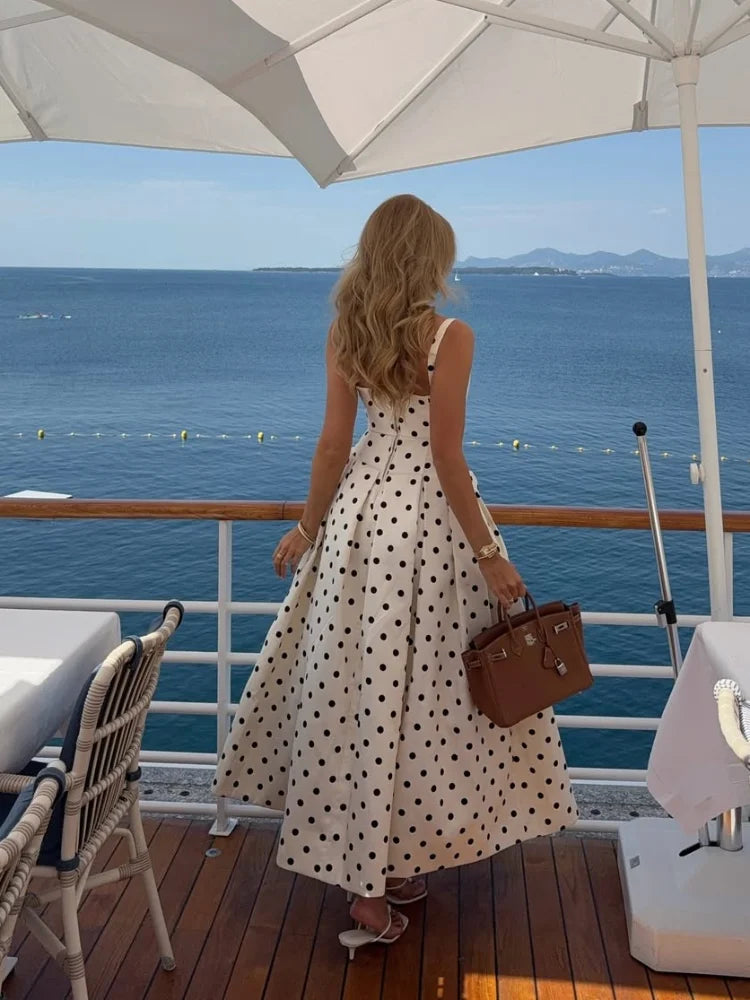 Woman in a polka dot maxi dress, perfect for summer casual and retro chic outfits.