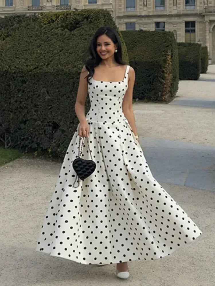 Woman in a polka dot maxi dress, perfect for summer casual and retro chic outfits.
