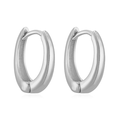 Close-up of 14K gold polished huggies earrings with secure hinge closure