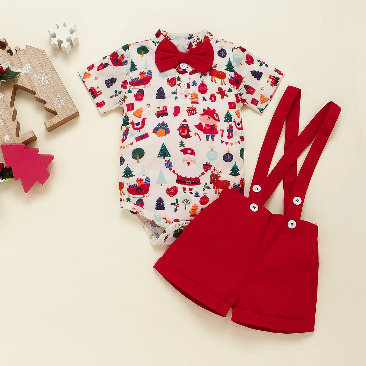 Newborn wearing festive bowtie Christmas romper with braces

