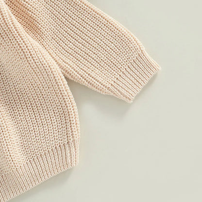 Toddler wearing cozy knit sweater for winter warmth

