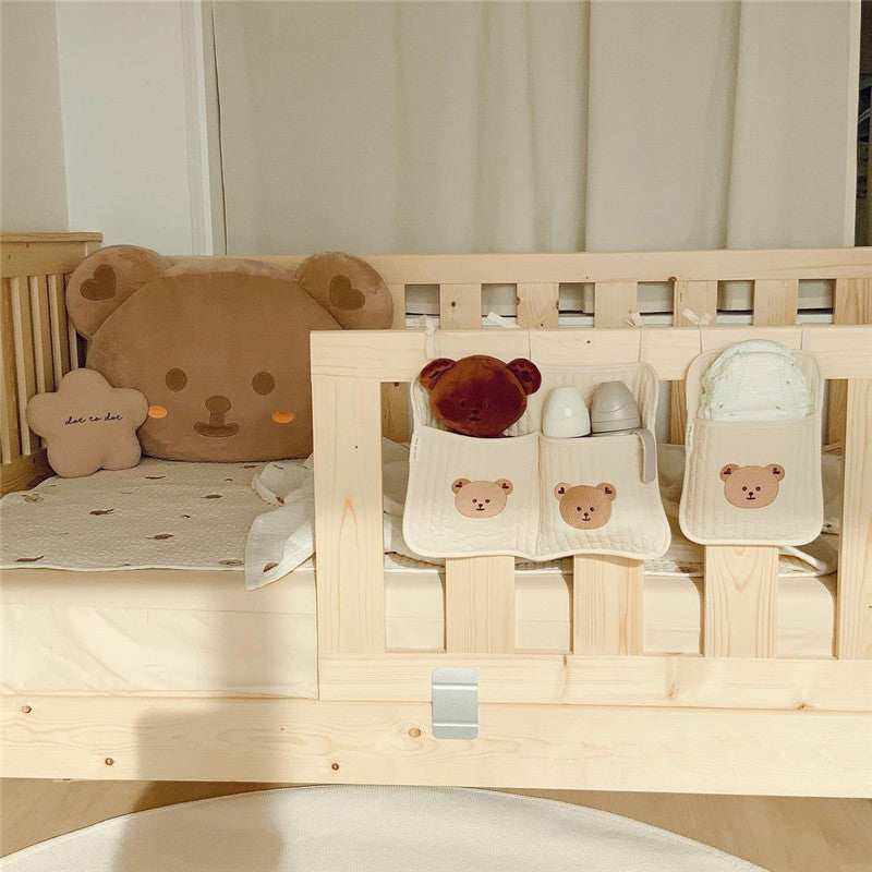 Bedside baby storage bag hanging on crib for holding diapers and bottles

