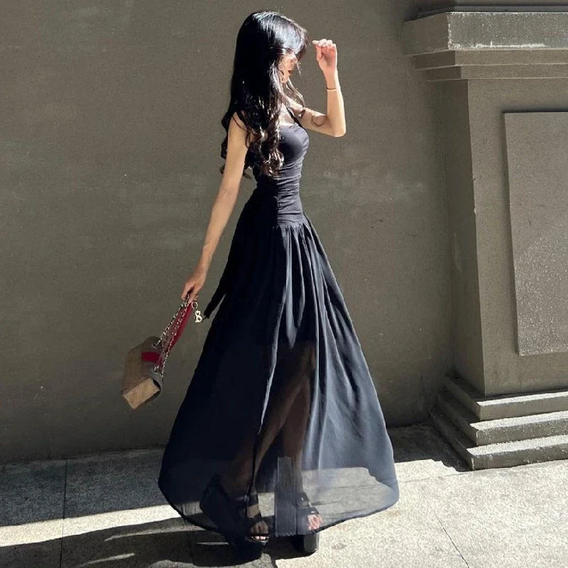 Woman in a sexy black maxi dress with ruched bodycon design, perfect for summer parties and evening events.