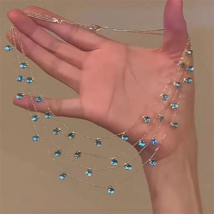 Silver-tone blue gem necklace and earrings set with layered waterfall design