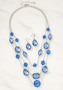 Silver-tone blue gem necklace and earrings set with layered waterfall design