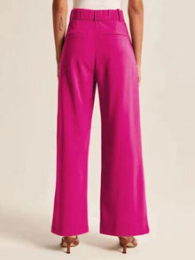 Model wearing elegant high waist wide leg pants in beige color

