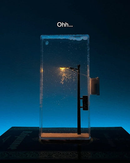 Warm LED snowfall night lamp glowing in a cozy winter bedroom

