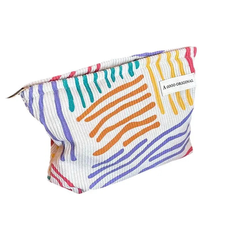 Corduroy cosmetic bag with colorful stripes for travel, skincare, and makeup storage

