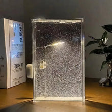Warm LED snowfall night lamp glowing in a cozy winter bedroom

