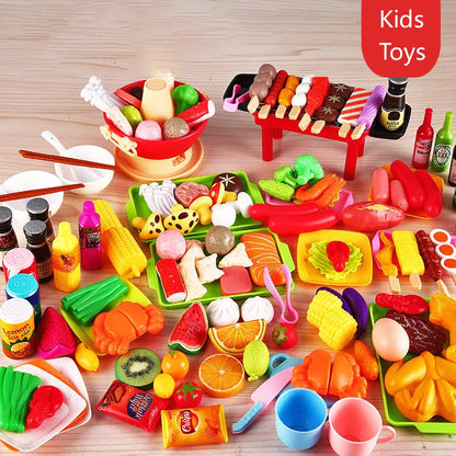 Assorted pretend play kitchen toys including simulation food items and barbecue accessories laid out on a surface.