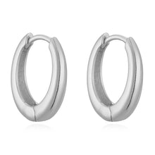 Close-up of 14K gold polished huggies earrings with secure hinge closure