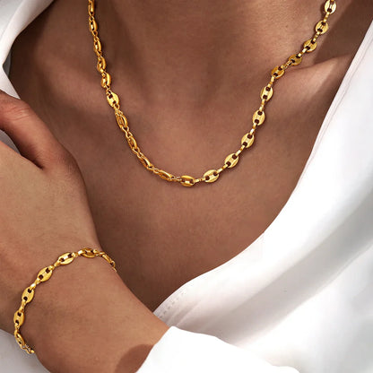 Stainless steel necklace and bracelet jewelry set on white background