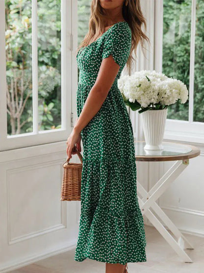 Woman in a vintage print maxi dress with puff sleeves and square collar, perfect for summer beach and casual outings.