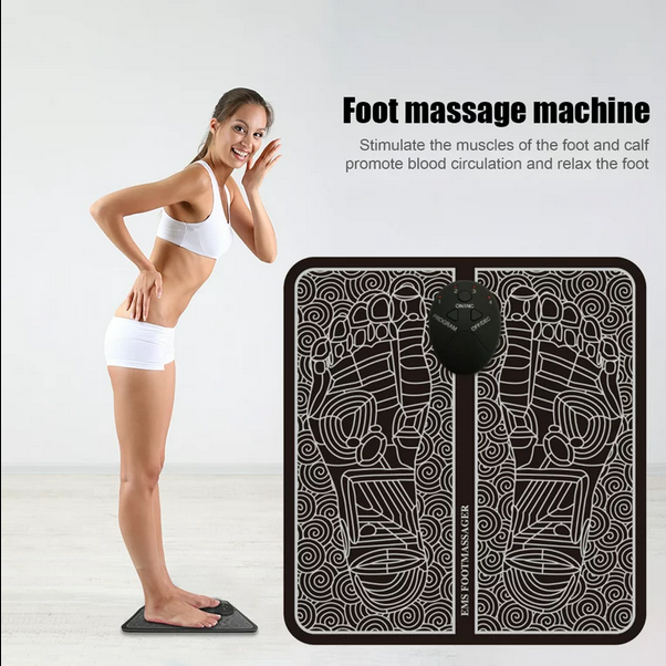 Person using portable EMS foot massager pad at home

