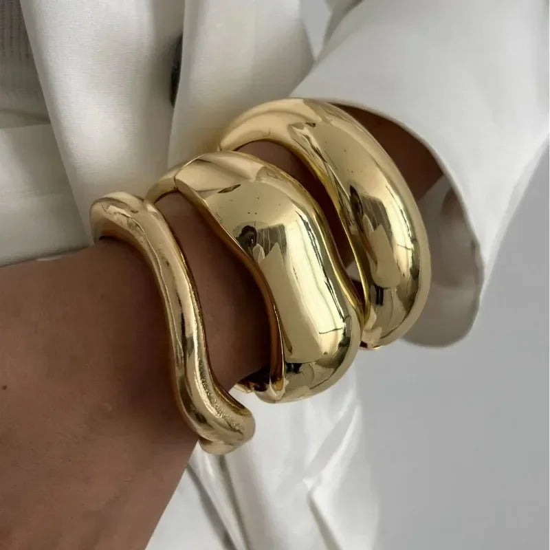 Wide cuff bangles in gold and silver with geometric design