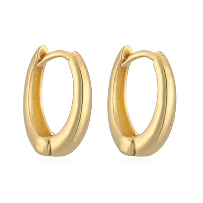 Close-up of 14K gold polished huggies earrings with secure hinge closure