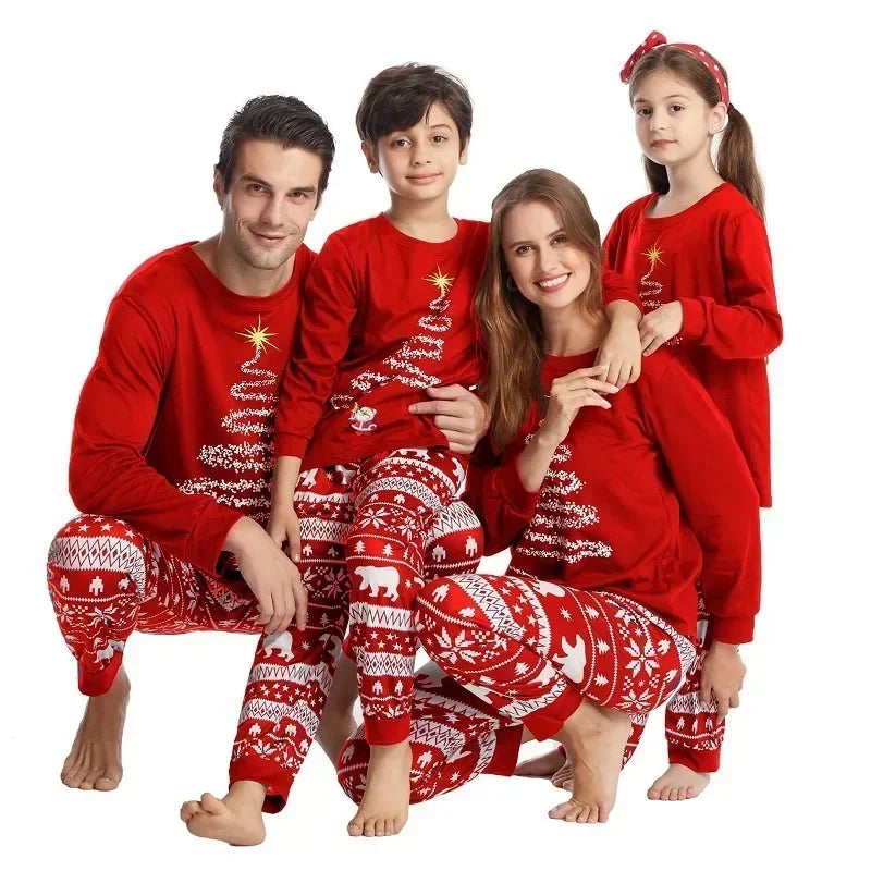 Family wearing matching polar bear and tinsel tree Christmas pajamas

