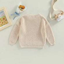Toddler wearing cozy knit sweater for winter warmth

