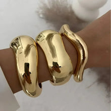 Wide cuff bangles in gold and silver with geometric design