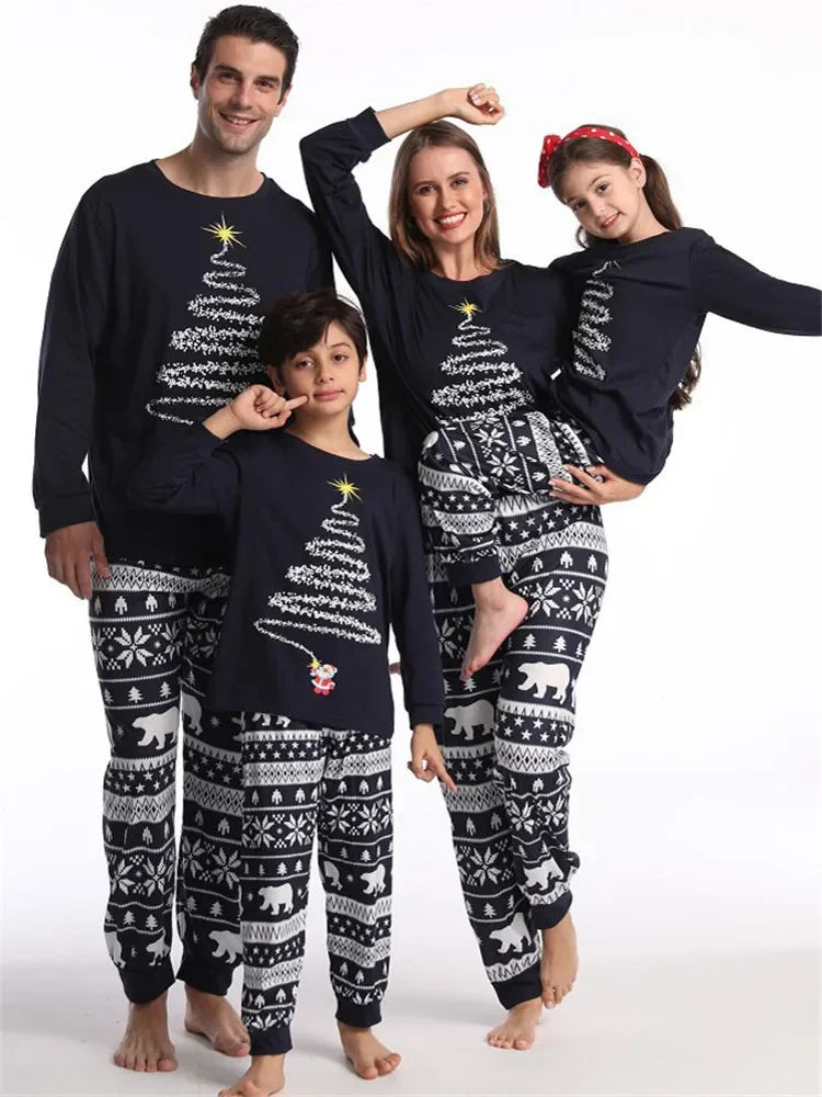Family wearing matching polar bear and tinsel tree Christmas pajamas

