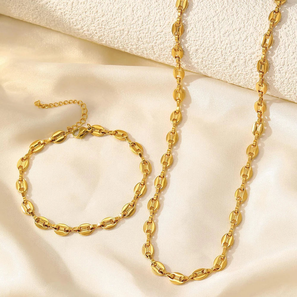 Stainless steel necklace and bracelet jewelry set on white background