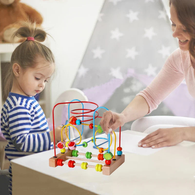 Toddler playing with Montessori wooden roller coaster bead maze toy


