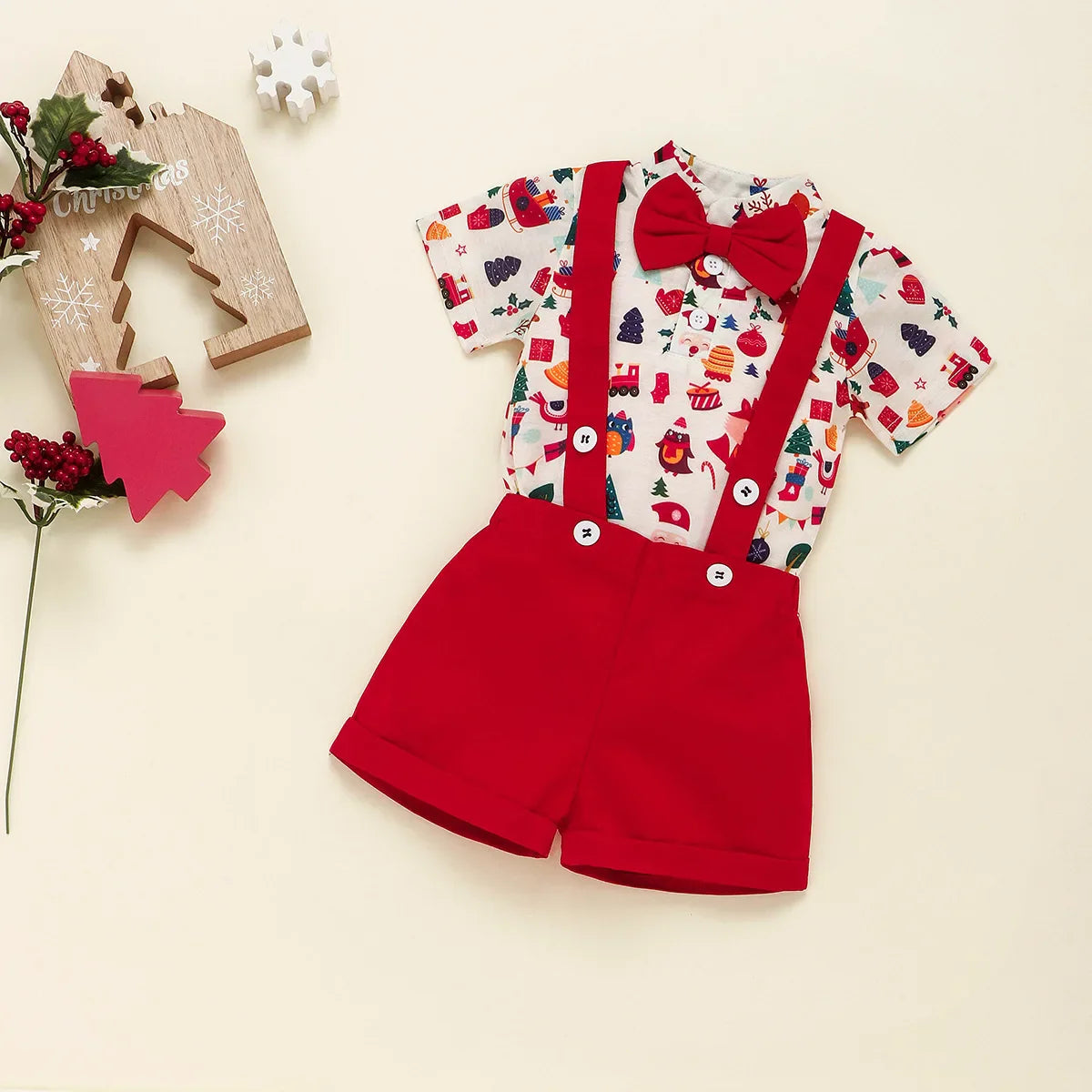 Newborn wearing festive bowtie Christmas romper with braces


