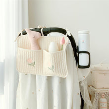 Bedside baby storage bag hanging on crib for holding diapers and bottles

