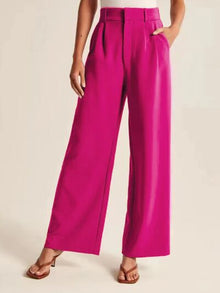 Model wearing elegant high waist wide leg pants in beige color

