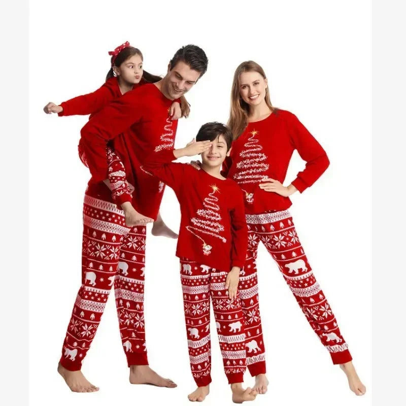 Family wearing matching polar bear and tinsel tree Christmas pajamas

