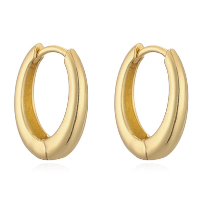 Close-up of 14K gold polished huggies earrings with secure hinge closure