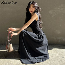 Woman in a sexy black maxi dress with ruched bodycon design, perfect for summer parties and evening events.
