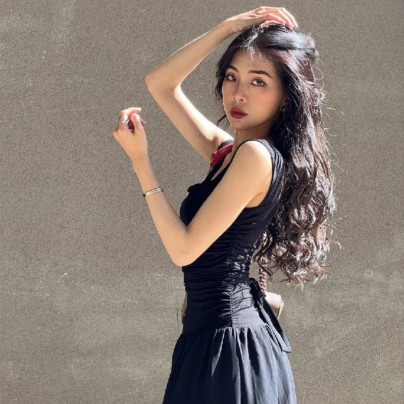 Woman in a sexy black maxi dress with ruched bodycon design, perfect for summer parties and evening events.