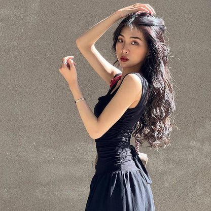 Woman in a sexy black maxi dress with ruched bodycon design, perfect for summer parties and evening events.