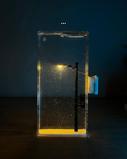 Warm LED snowfall night lamp glowing in a cozy winter bedroom

