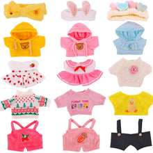 A collection of various outfits for a plush duck toy, including a yellow hoodie, pink dresses, a blue shirt, and other clothing items.