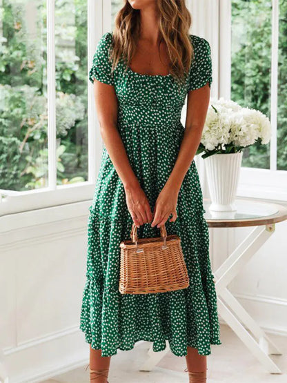 Woman in a vintage print maxi dress with puff sleeves and square collar, perfect for summer beach and casual outings.