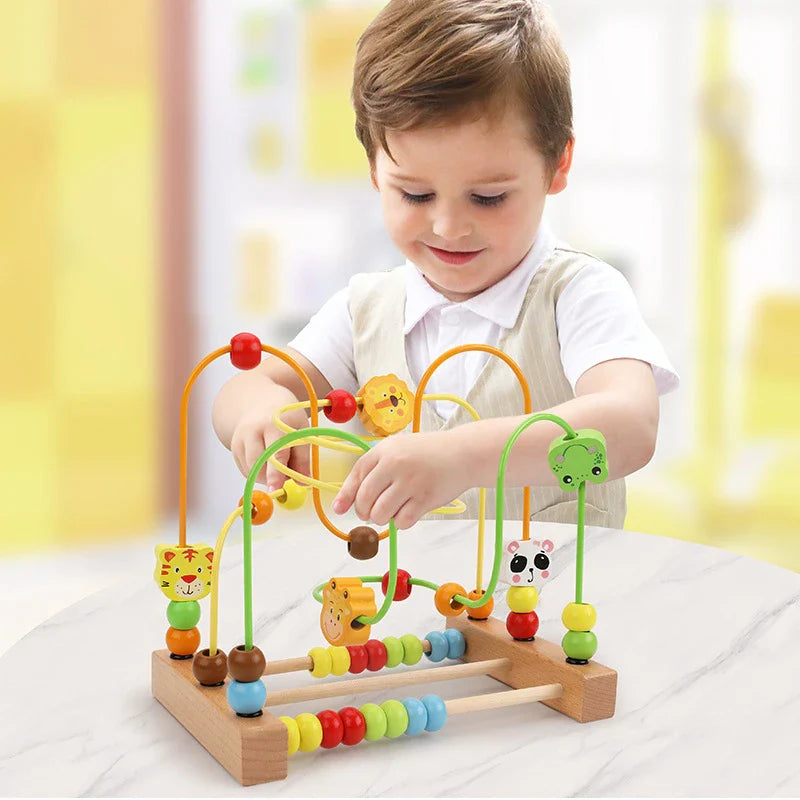 Toddler playing with Montessori wooden roller coaster bead maze toy


