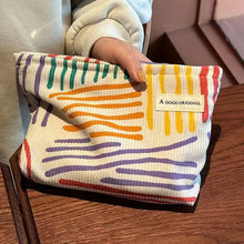 Corduroy cosmetic bag with colorful stripes for travel, skincare, and makeup storage

