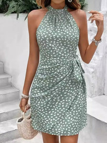 Woman wearing women's floral printed mini dresses at a sunny outdoor event