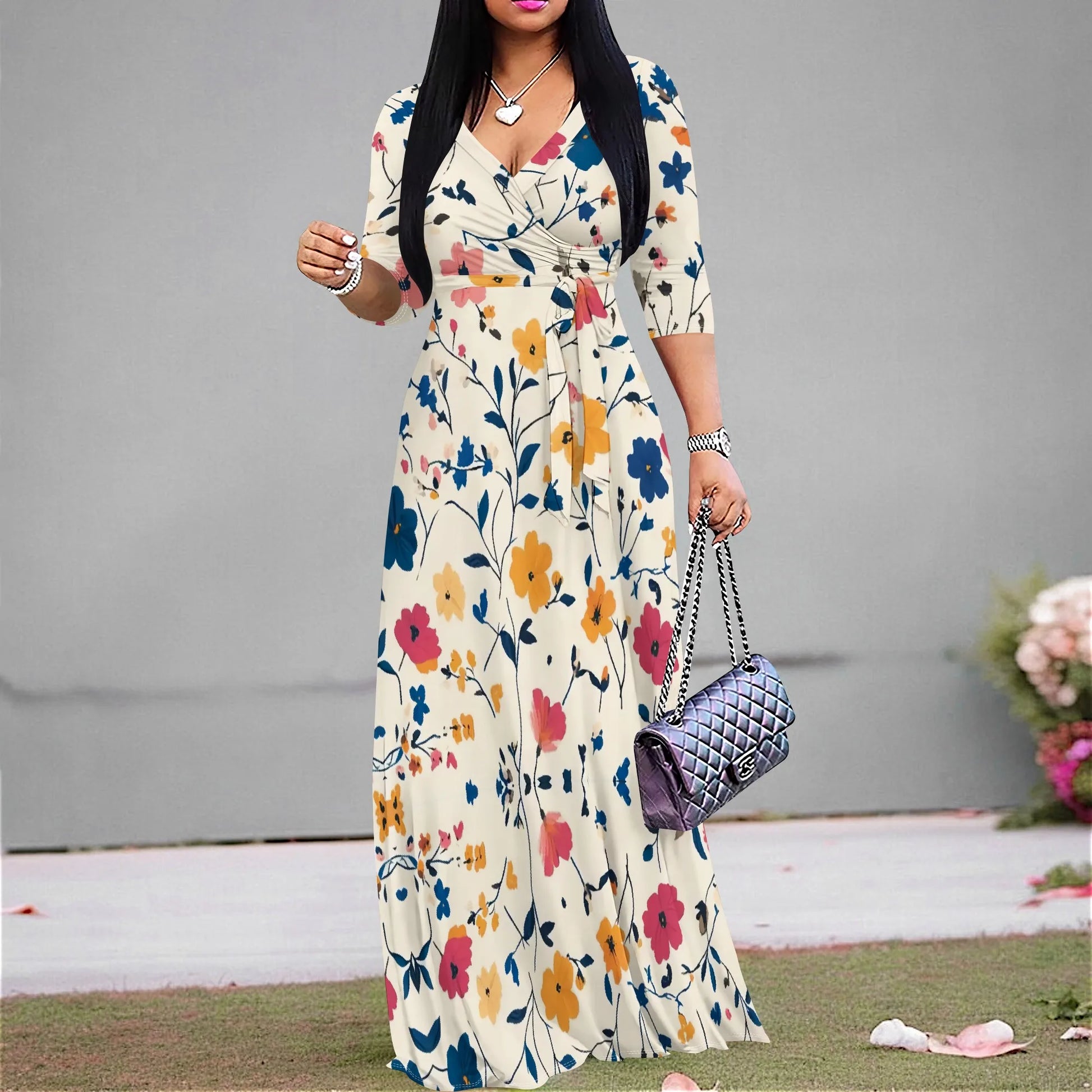 Woman in a vintage floral maxi dress with V-neck and ruched belt, perfect for casual summer style.
