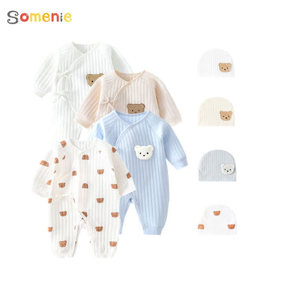 A collection of baby bodysuits in various designs, colors, and patterns, including plain, animal printed, and geometric designs, accompanied by matching hats.