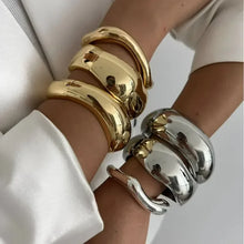 Wide cuff bangles in gold and silver with geometric design