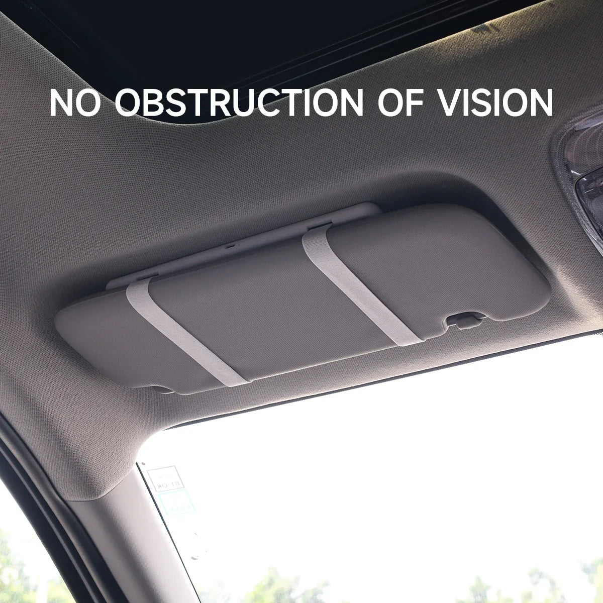 Woman using LED visor vanity mirror in car for makeup

