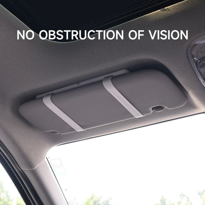 Woman using LED visor vanity mirror in car for makeup

