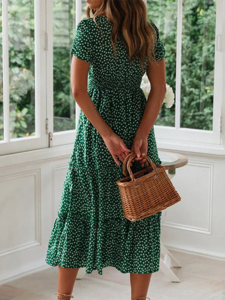 Woman in a vintage print maxi dress with puff sleeves and square collar, perfect for summer beach and casual outings.