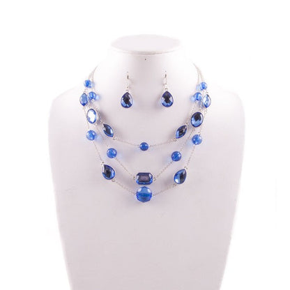 Silver-tone blue gem necklace and earrings set with layered waterfall design