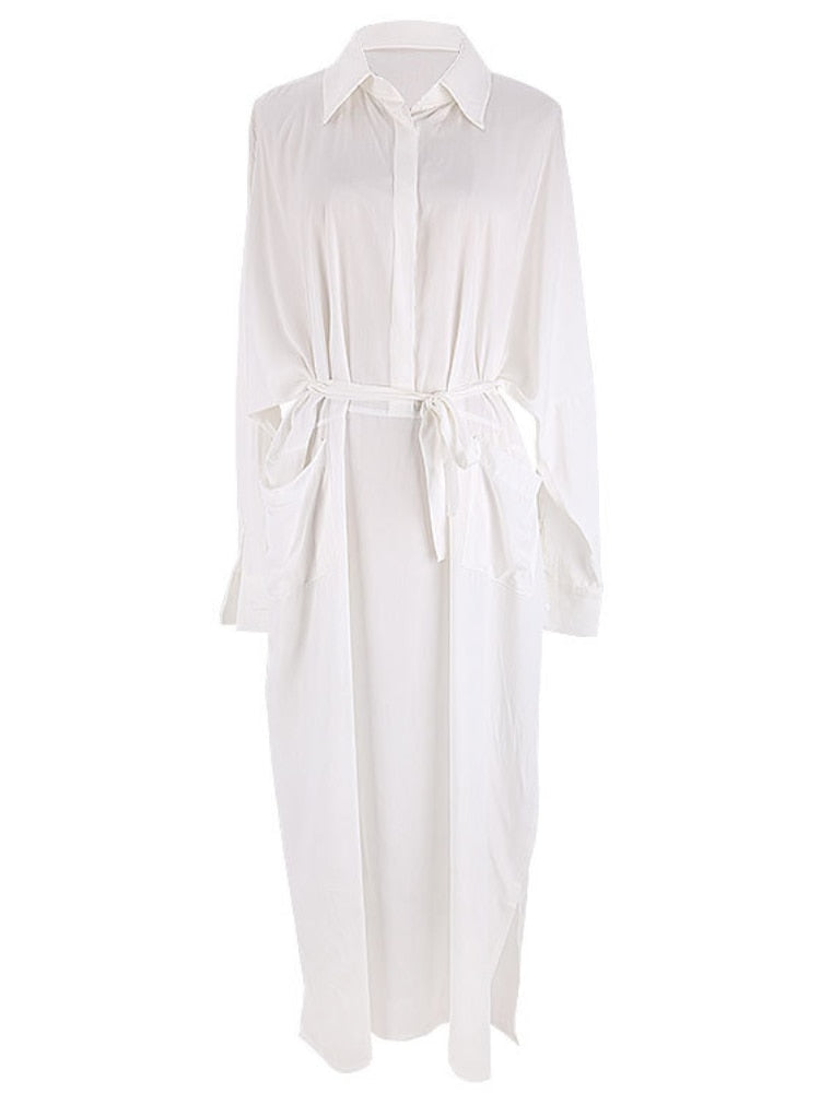 Woman wearing a white maxi beach dress kaftan as a swimsuit cover-up, perfect for summer beach and pool outings.